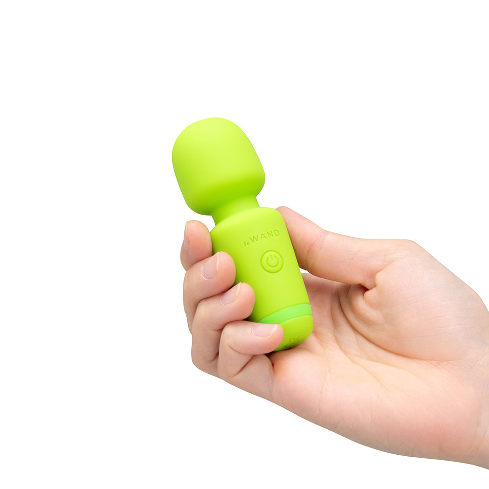 Le Wand Essentials Mini Wand Vibe Pocket-sized Vibrator in hand, compact and ready for targeted stimulation.