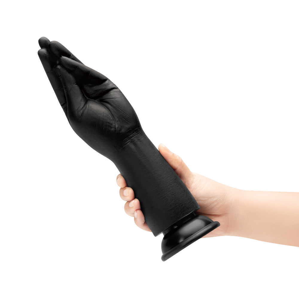 B-vibe Essentials Silicone Hand Fisting Dildo Black held in hand, showcasing its unique hand-shaped design.