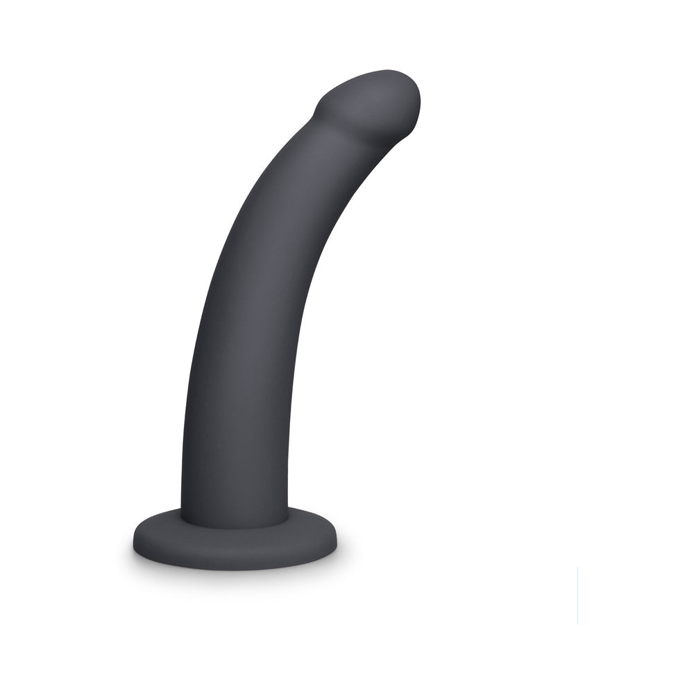 b-Vibe Essentials 7 Inch Smooth Silicone Dildo Black on a white background, showcasing its sleek design and smooth silicone finish.