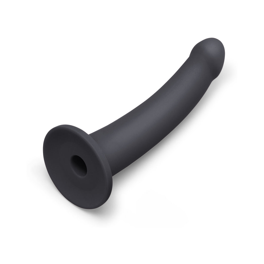 b-Vibe Essentials 7 Inch Smooth Silicone Dildo Black on a white background, showcasing its sleek design and smooth finish.
