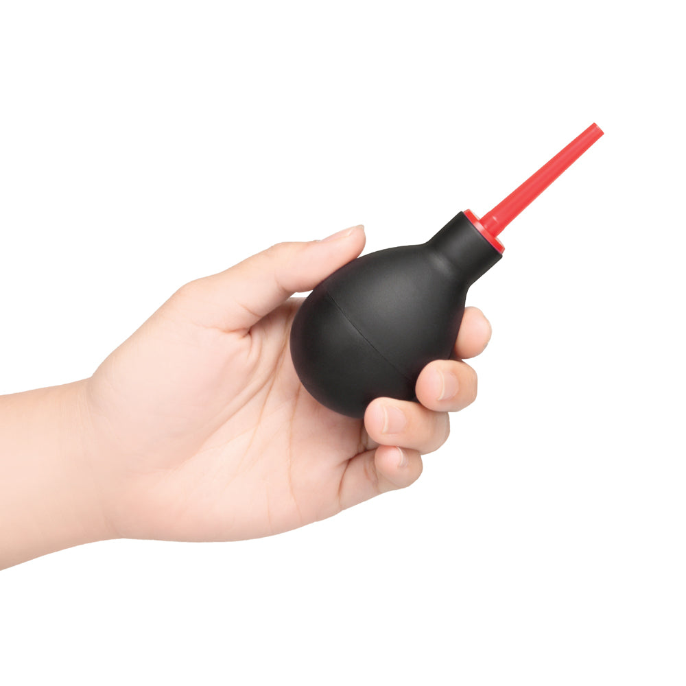 b-Vibe Essentials Mini Travel Enema Set 30 ml squeezable bulb held in hand for convenient anal hygiene.