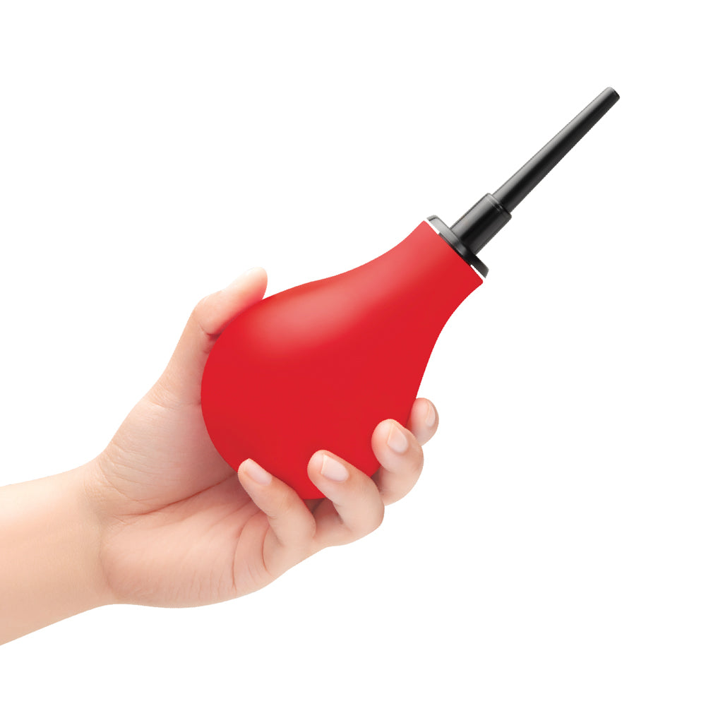 b-Vibe Essentials Hydrobulb Anal Douche 200 ml in a hand showcasing its squeezable design for hygiene.