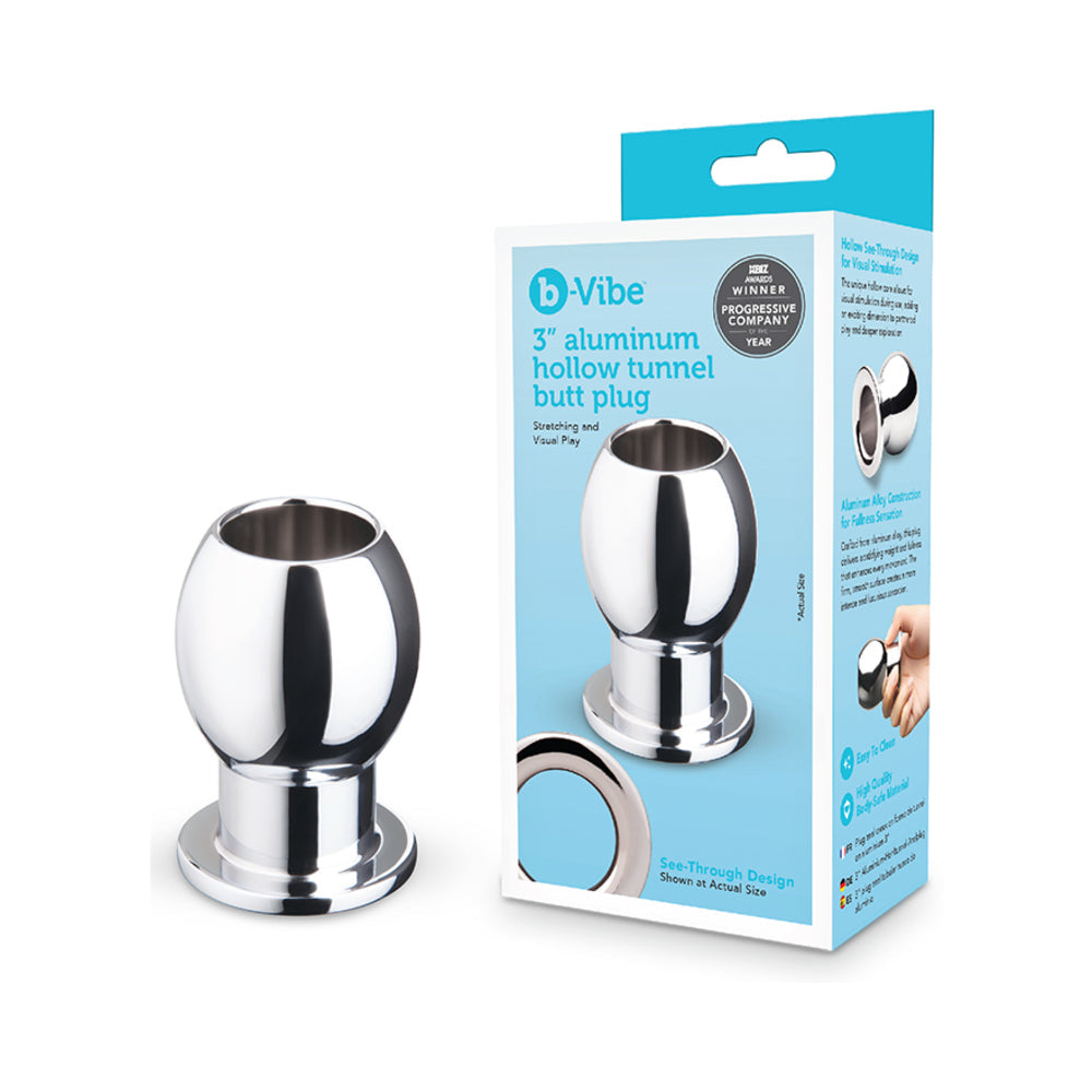 B-vibe Essentials 3 Inch Aluminum Hollow Tunnel Butt Plug displayed with packaging for visual appeal and functionality.