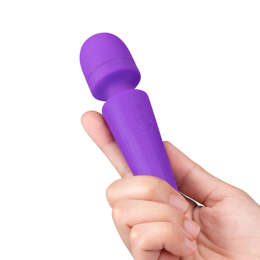 Together Glow On The Go Mini Wand Vibrator Purple held in hand, showcasing its compact design and soft silicone finish.