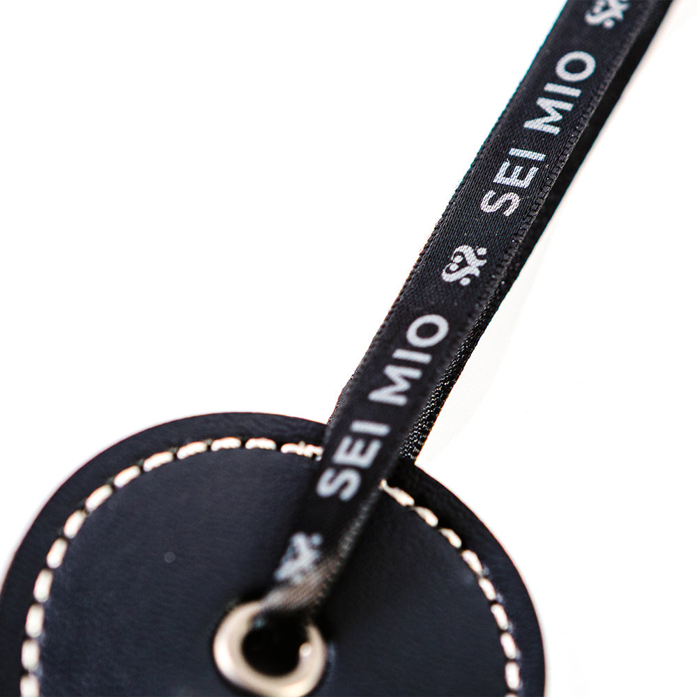 Sei Mio Double Trouble Shhh Oops Double-Sided Paddle detail showing the ribbon and tag design.