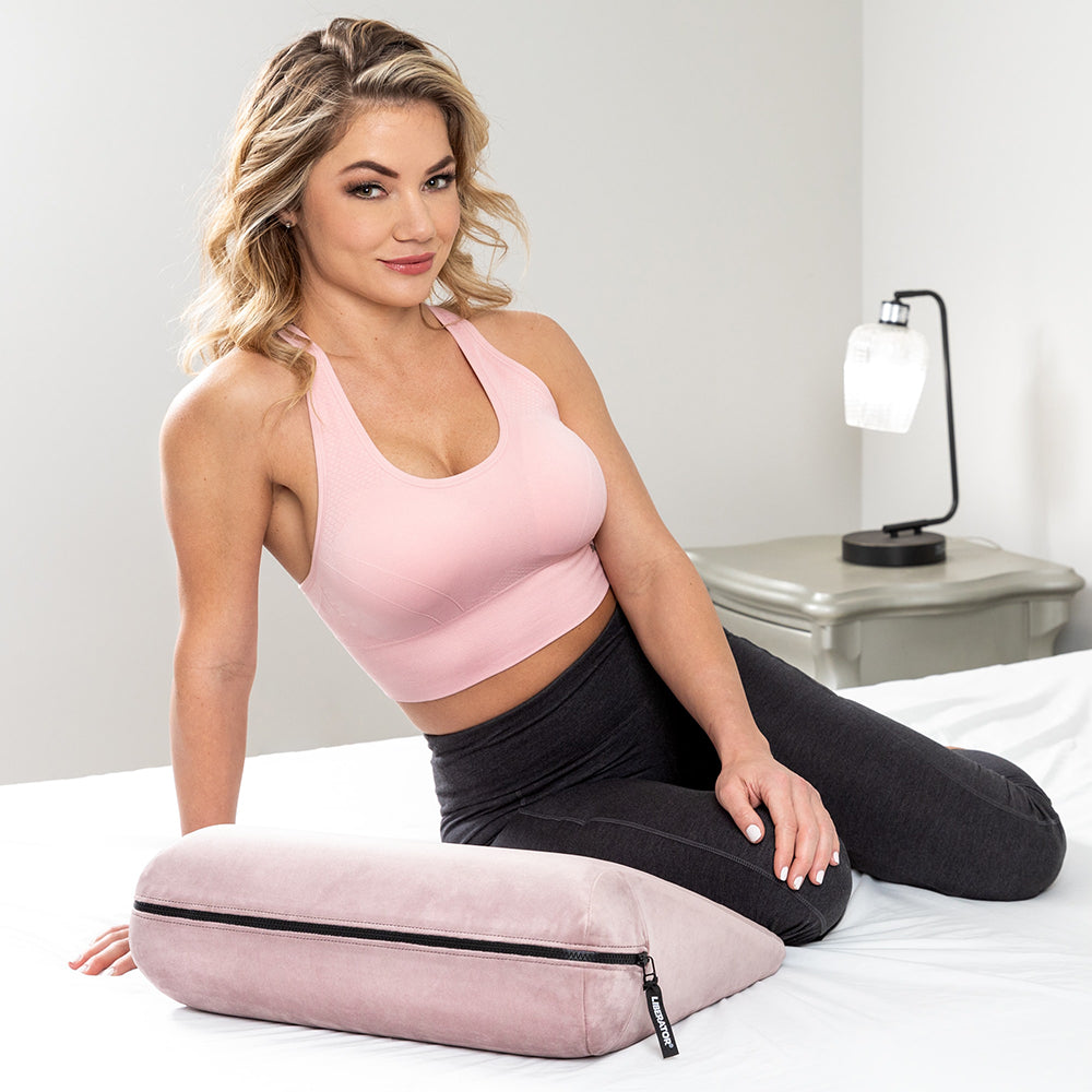 Liberator Jaz Original Rose Sex Positioning Pillow shown with a model for enhanced sexual comfort and support.