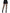 Leg Avenue Cracked Fishnet Tights One Size Black worn with a black mini skirt and heeled boots from the back.