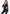 Model wearing Leg Avenue Wet Look Cat Suit Large Black, showcasing its glossy faux leather and plunging zipper front.