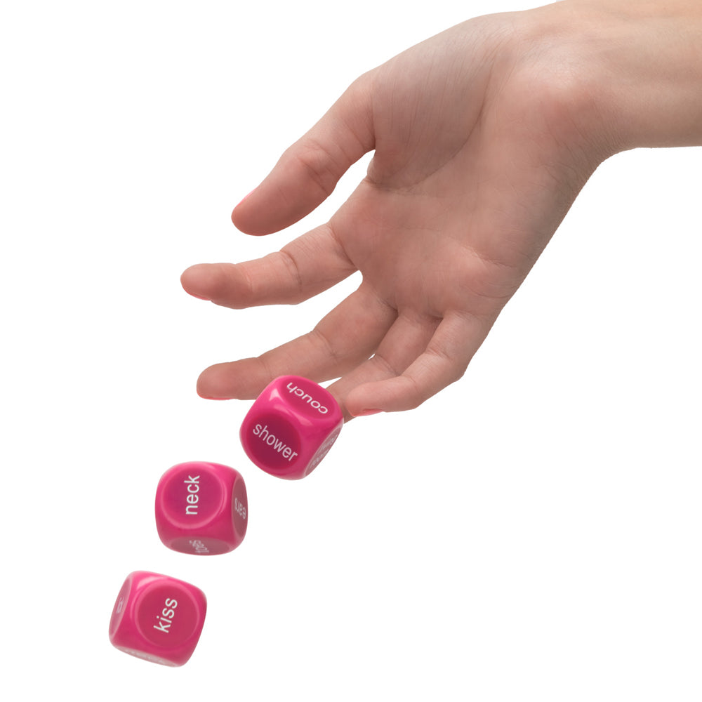 Utopia Naughty Party Dice in pink with hand throwing dice labeled kiss, neck, and shower for adult fun.
