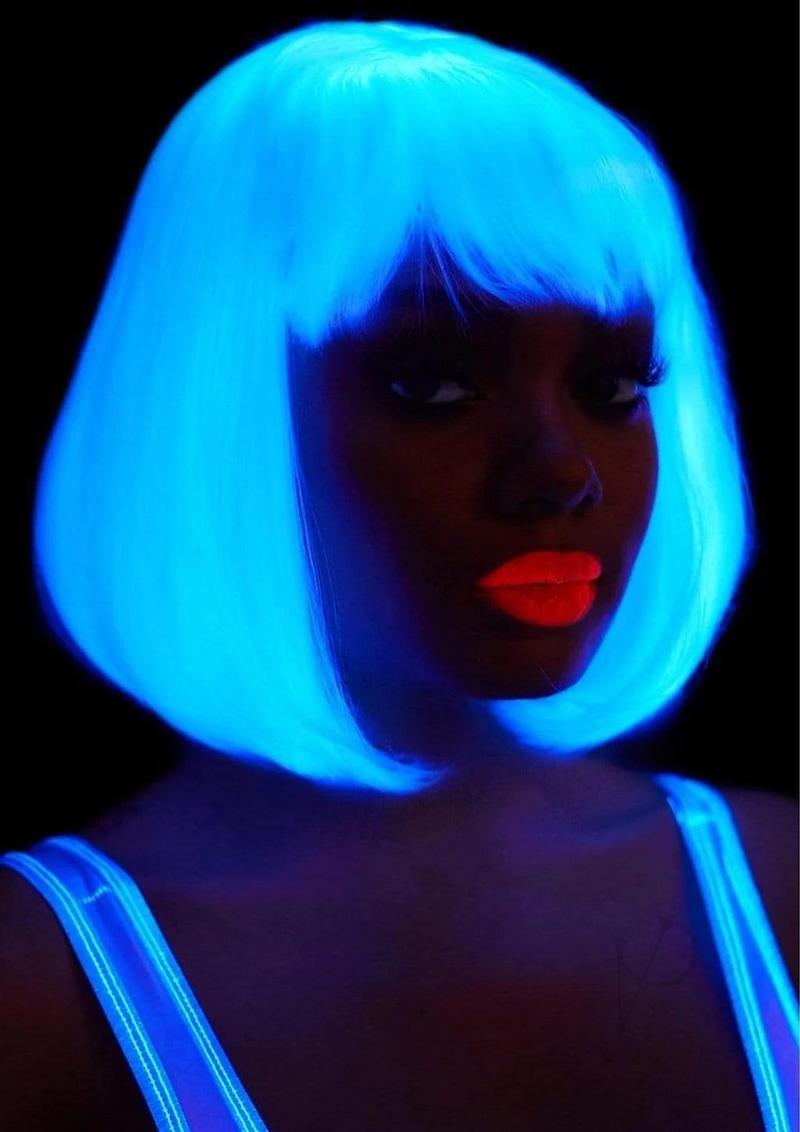 Leg Avenue Pearl Short Natural Bob Wig White worn by a model with glowing blue hair and bright orange lips.