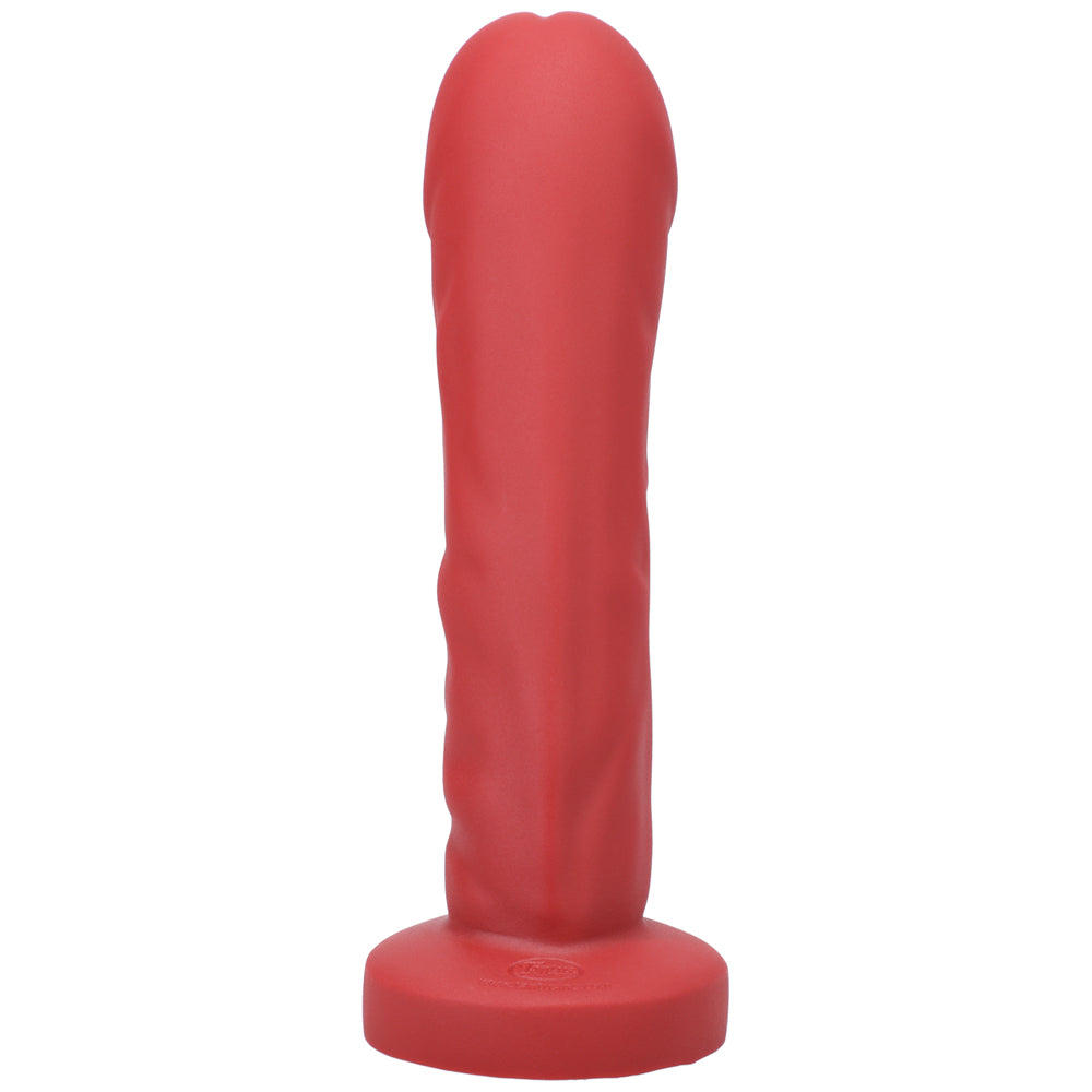 Tantus Grind Silicone Dildo True Blood Red standing upright, showcasing its realistic design and vivid red color.