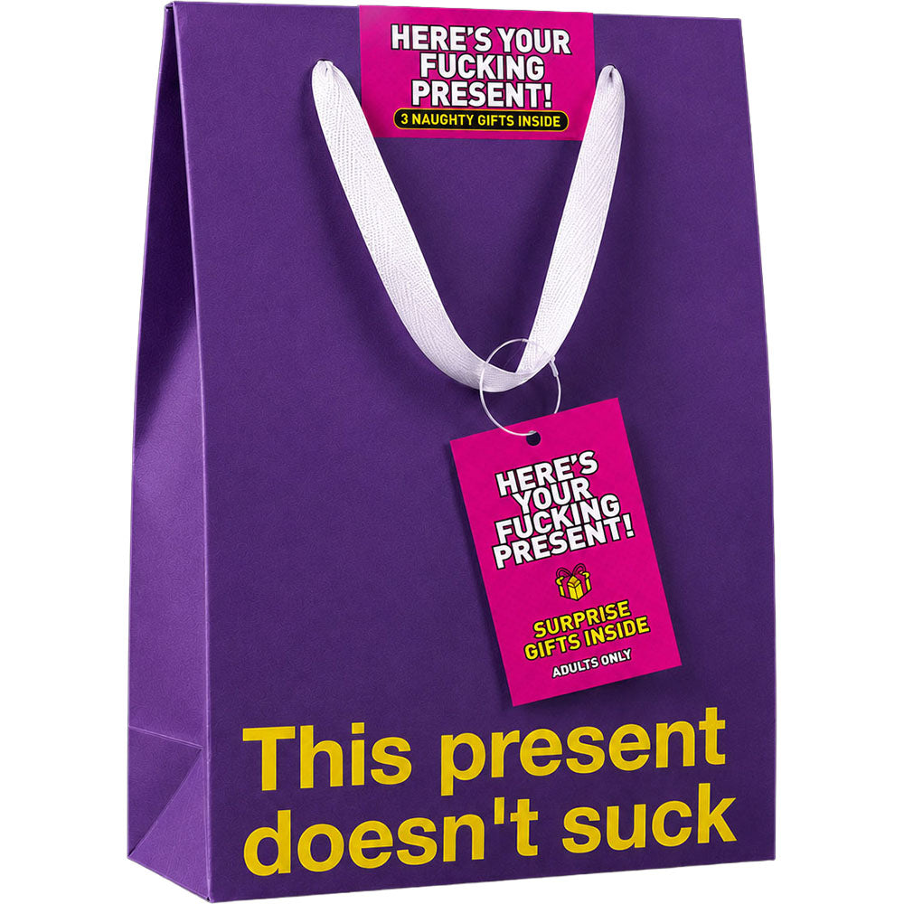Wood Rocket Here's Your Fucking Present Gag Gift purple gift bag with humorous text and tags for adults.