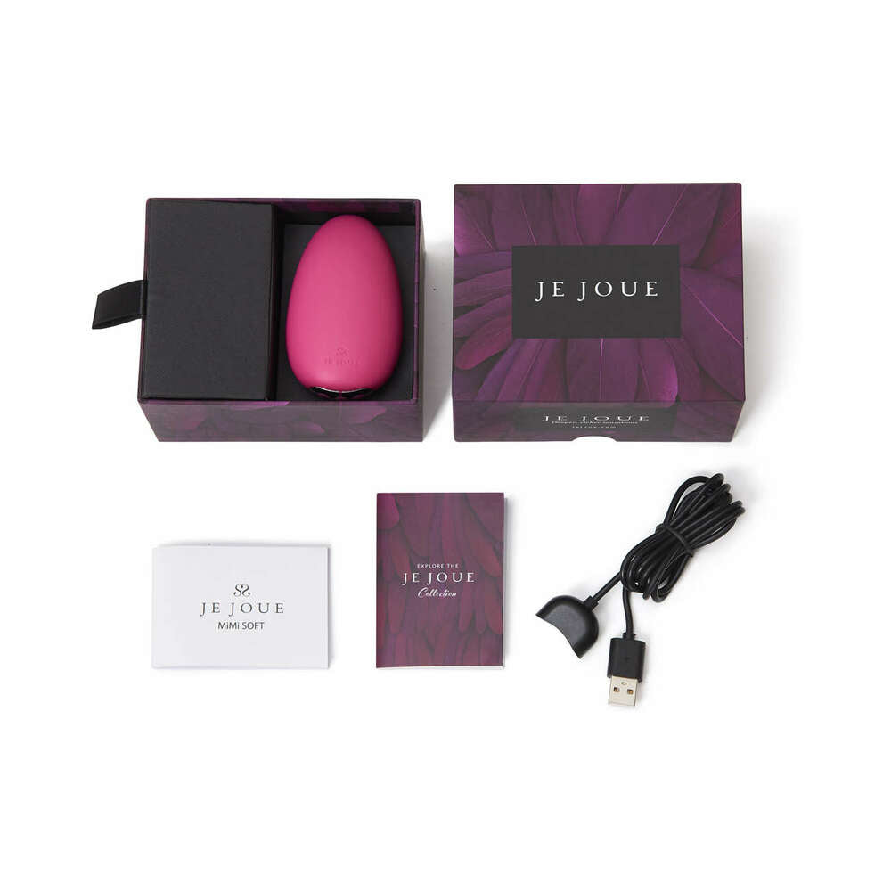 Je Joue Mimi Soft Silicone Clitoral Vibrator Fuchsia in packaging with charger and instruction manual.