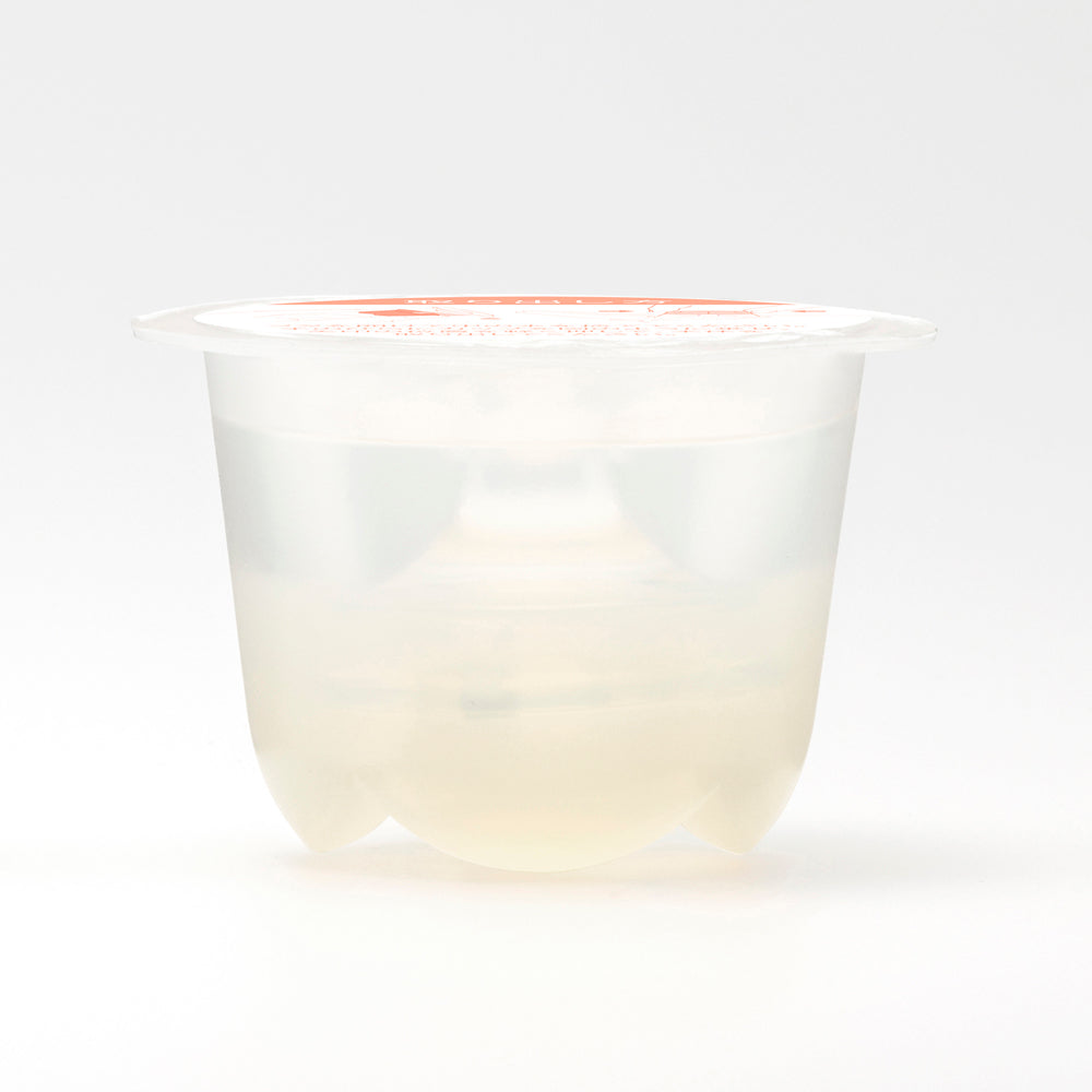 Iroha Petit Lily Disposable Clitoral Massager Clear in a transparent container showcasing its gel-like texture.