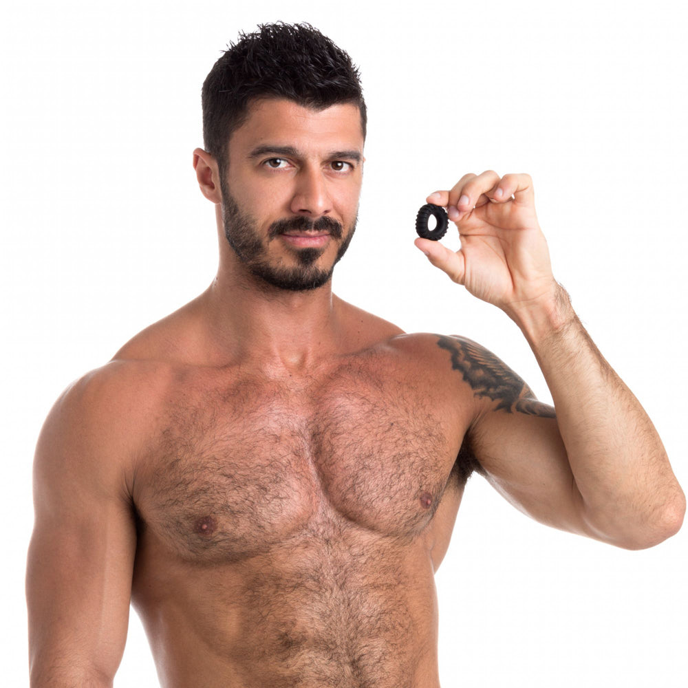 Man holding the Sport Fucker Traction Ring Liquid Silicone Cock Ring with a confident expression.