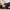 Close-up of a person holding the Dame Pillo Sex Position Pillow Indigo, showcasing its ergonomic design and soft fabric.