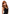 Pleasure Wigs Collection Aubrey Wig Red showcased on a model with long, wavy red hair and a stylish black outfit.