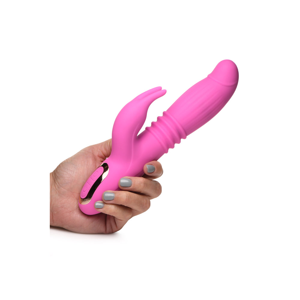 Inmi 35x Lil Swell Thrusting & Swelling Rabbit Vibrator held in hand, showcasing its ergonomic design and vibrant pink color.