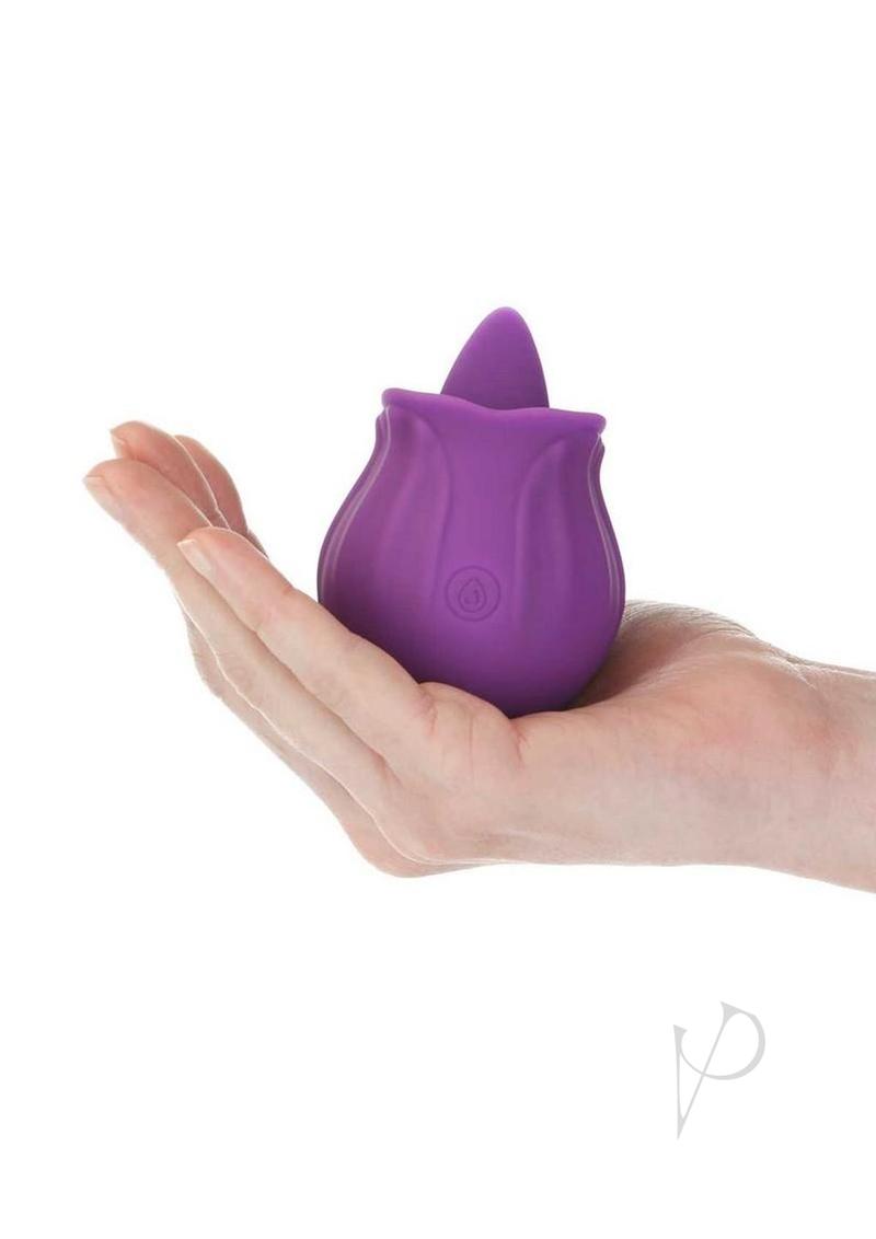 M'Lady Flickering Tongue Clitoral Stimulator Purple held in hand, showcasing its compact flower design.