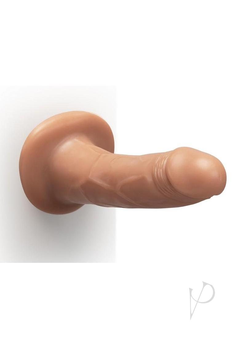 Together Realistic Dildo with Suction Base 6.5 Inch Caramel on a wall, ideal for hands-free intimate pleasure.