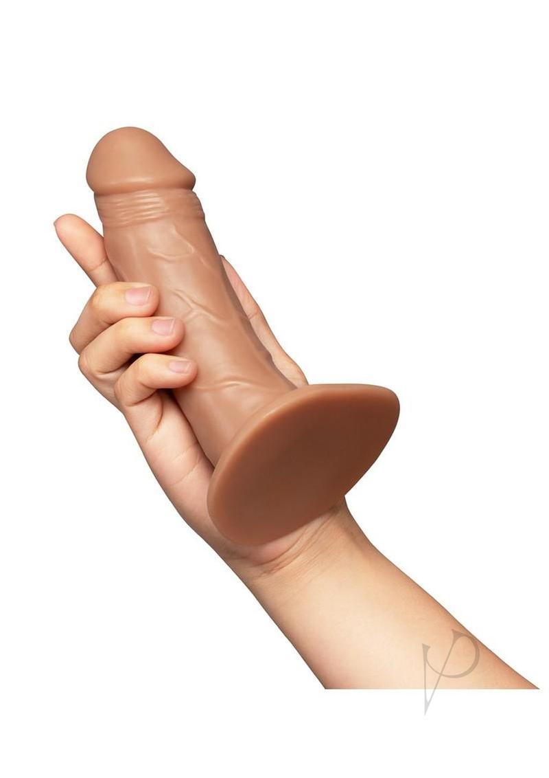 Together Realistic Dildo with Suction Base 6.5 Inch Caramel held in hand showcasing its lifelike design.