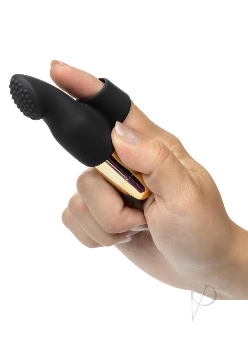 Close-up of a hand holding the Pleasure Kits Untamed Collection Bondage Kit bullet vibrator for sensual exploration.