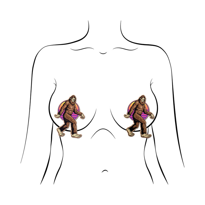 Pastease Sasquatch Bigfoot Pasties featuring playful designs on a model's chest, perfect for festivals and costumes.