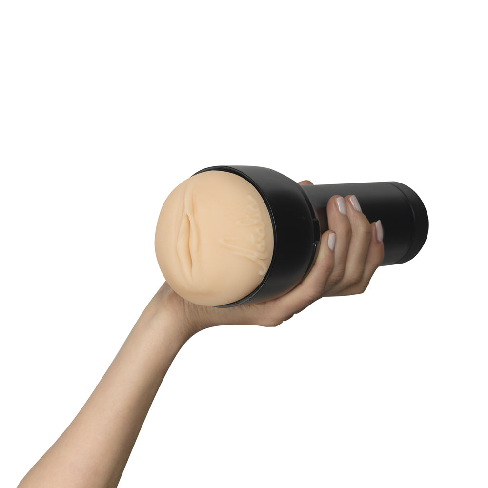 Feel Natalia Starr Stroker By Kiiroo in a hand showcasing its realistic design and intimate anatomy.