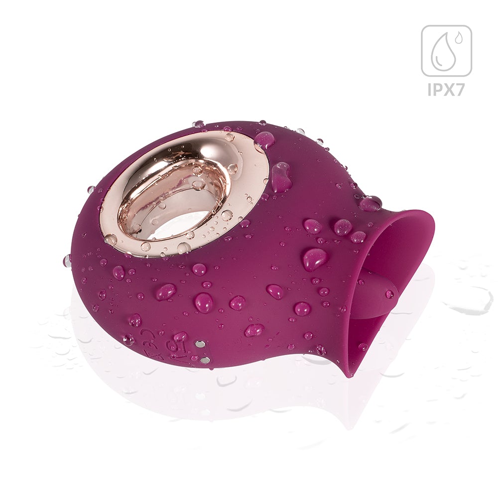 Honey Play Box Alvina Tongue Licking Clitoral Vibrator in rich magenta with water droplets.