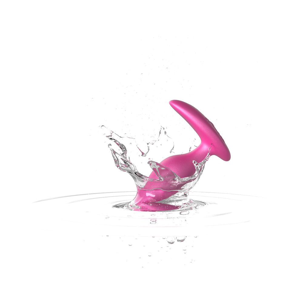 We-Vibe Ditto Plus Vibrating Anal Plug Cosmic Pink splashing in water, showcasing its sleek design and body-safe silicone.