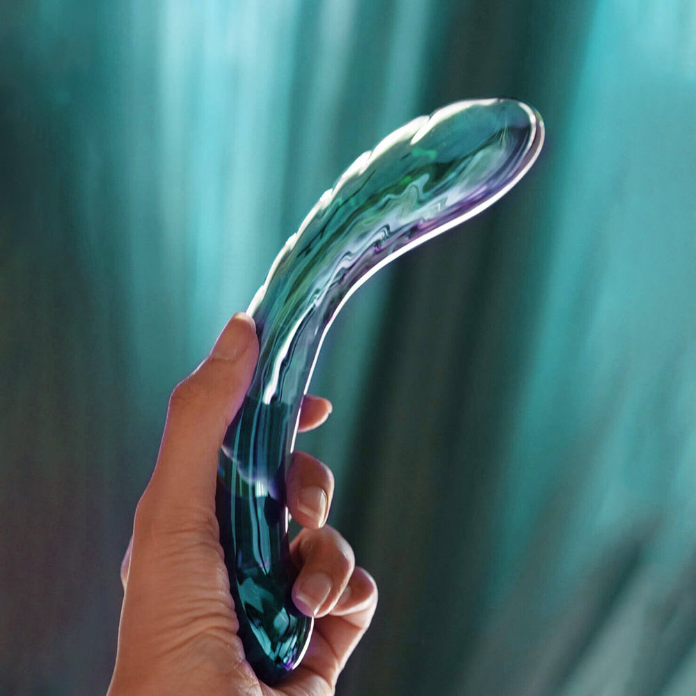 Biird Kalii Glass G-spot Dildo held in hand, showcasing its elegant design and smooth glass surface.