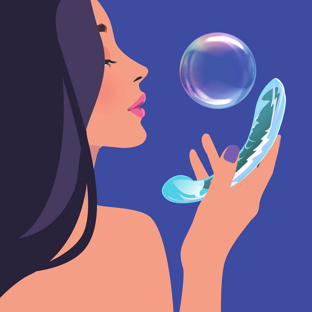 Woman holding a Biird Kalii Glass G-spot Dildo with bubbles in a serene setting.