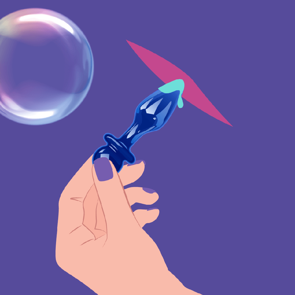 Hand holding Biird Anii Glass Anal Plug, with a bubble in the background, showcasing its elegant design.