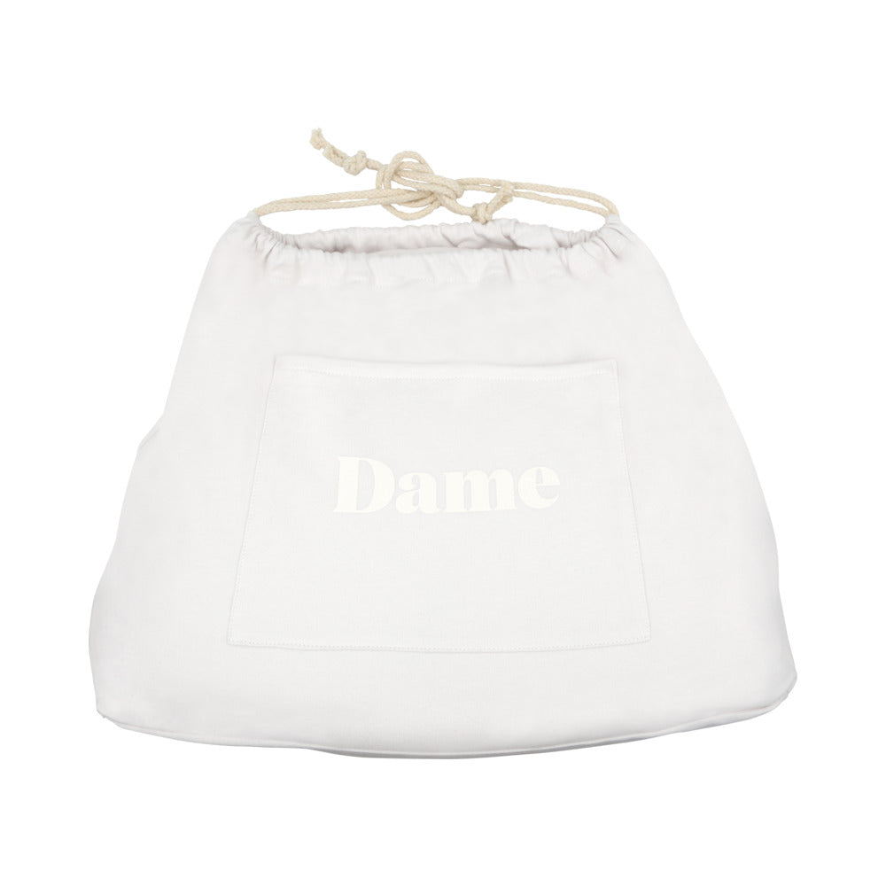 Dame Pillo Sex Position Pillow Oat storage bag with drawstring closure in white fabric.