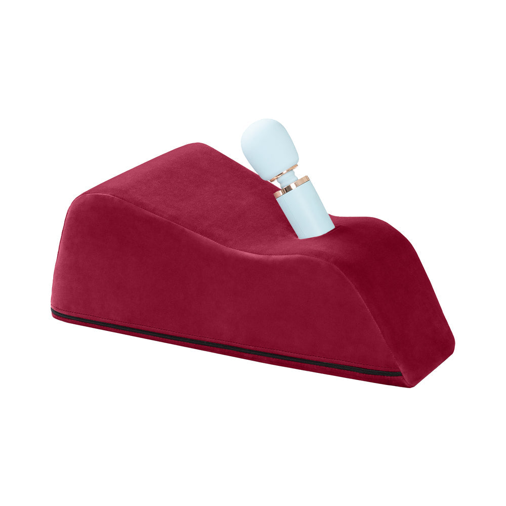 Liberator Wanda Toy Mount Merlot with a wand massager resting on the plush mount providing hands-free support.