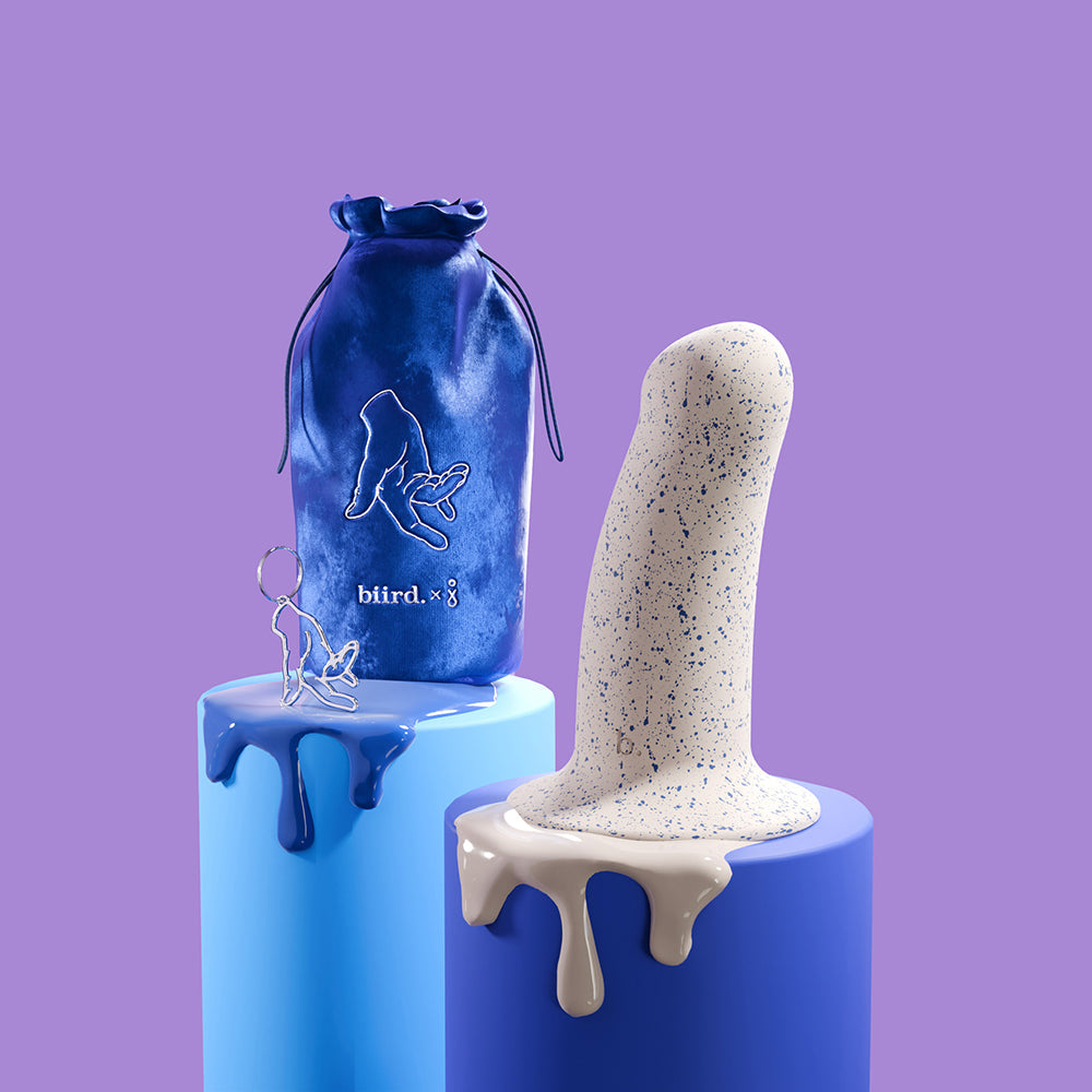 Biird Boo 5.5 Inch Soft Silicone Suction Cup Dildo Blue displayed with stylish packaging on colorful pedestals.