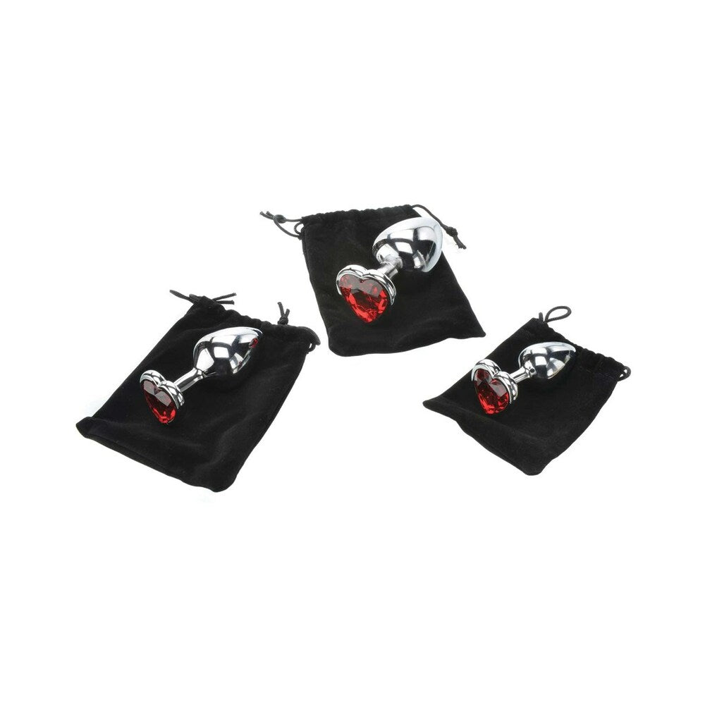 Adam & Eve Three Hearts Gem Anal Plug Set displayed in three black pouches with heart-shaped jewel bases.