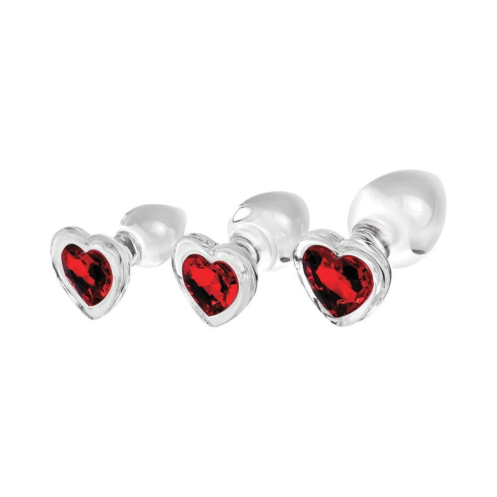 Adam & Eve Red Heart Gem Glass Plug Set featuring three graduated glass plugs with red heart gems.