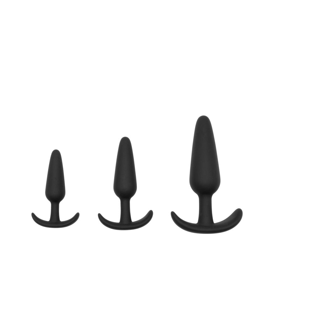 Adam & Eve Naughty Silicone Anal Trainer Kit Black features three graduated black silicone butt plugs for comfortable exploration.
