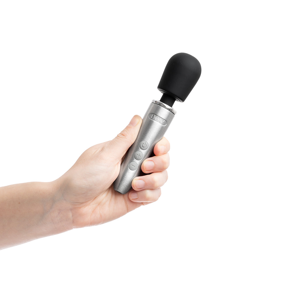 Doxy Go Travel-sized Wand Massager Silver held in hand, showcasing its sleek design and compact size.