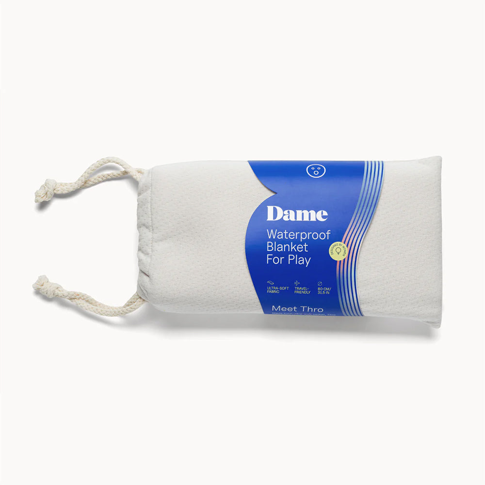Dame Thro Waterproof Blanket for Play Oat neatly packaged, showcasing its travel-friendly and waterproof design.