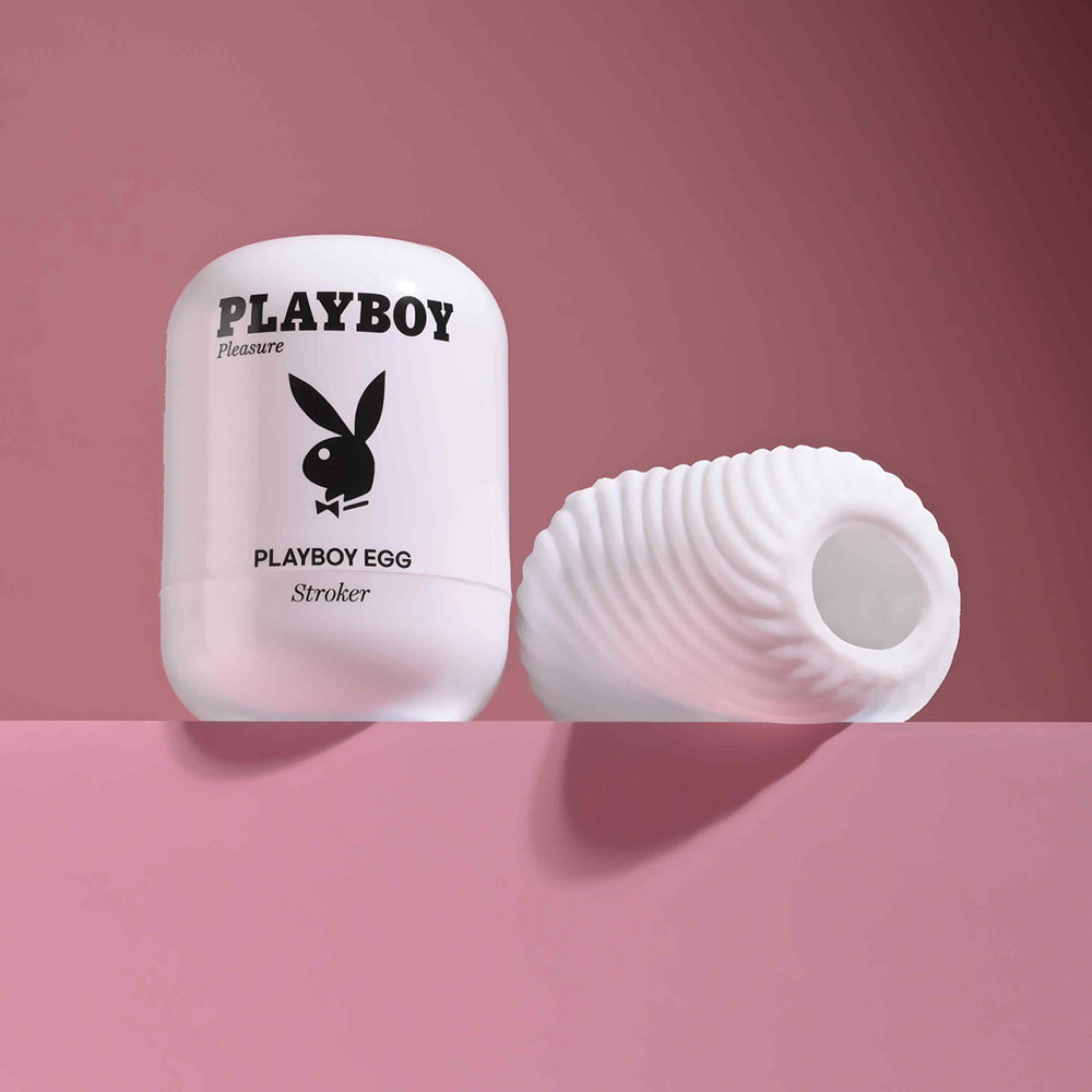 Playboy Pleasures 70th Anniversary Egg Stroker on a pink background, showcasing its compact and modern design.