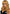 Leg Avenue 24 Inch Misfit Long Wavy Bang Wig Dark Blond with flowing waves and face-framing bangs.