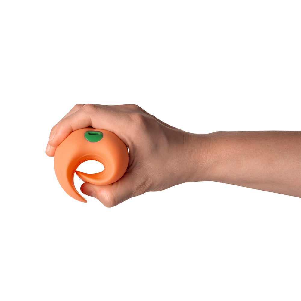 Hand holding the Emojibator Peach Vibrating Stroker, showcasing its compact design and grip.
