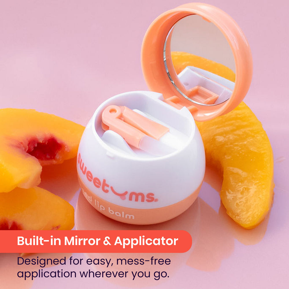 Sweetums Peach Flavored Lip Balm in a compact with mirror and applicator, featuring juicy peach slices.