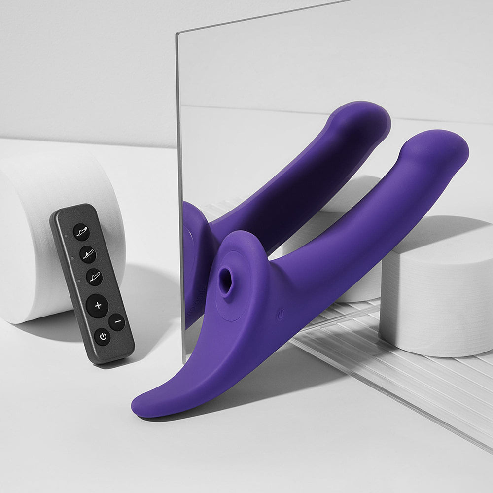 Image of Strap-on-me Multi Orgasm Dildo Medium Purple with remote control demonstrating its design and features.