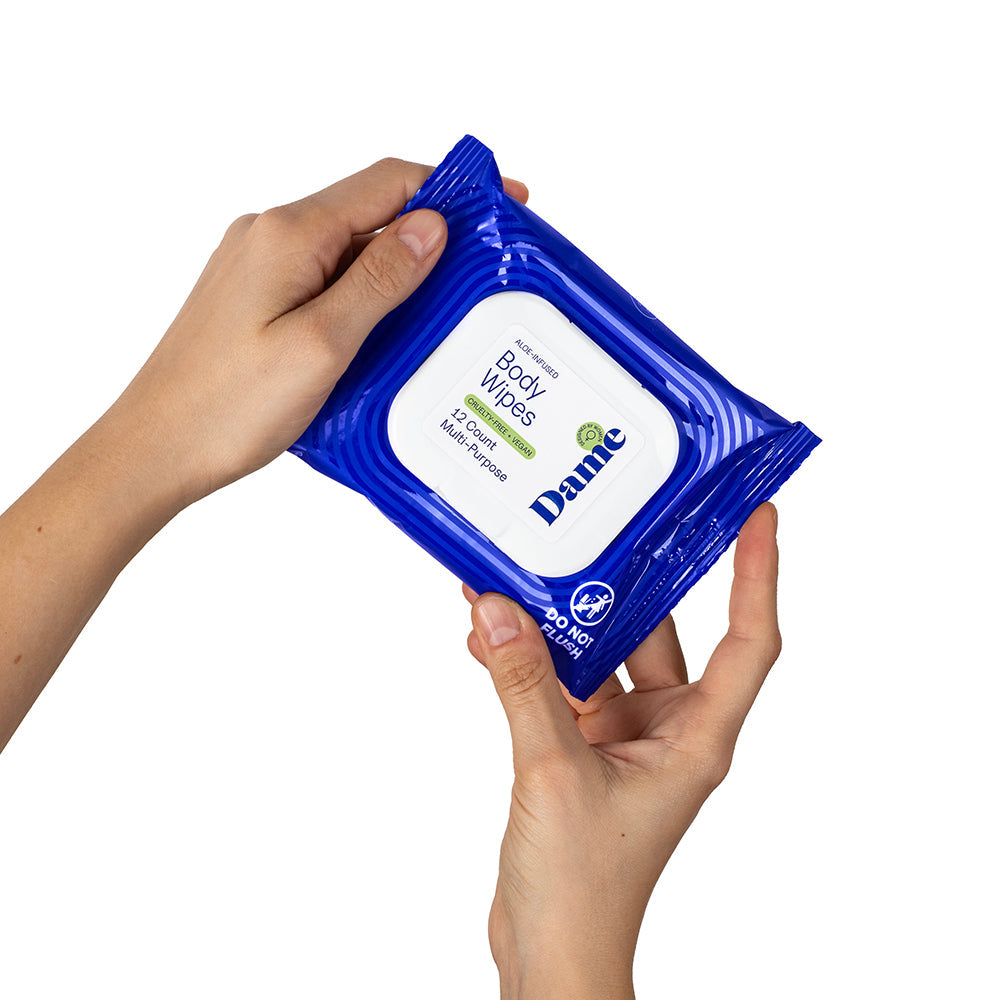 Dame Body Wipes 12 count Aloe & Cucumber package being held in hands.