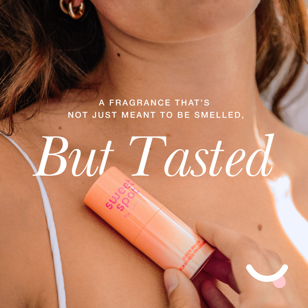 Sweetums Sweet Spot Flavored Fragrance Golden Vanilla packaging held against skin, highlighting its edible fragrance.