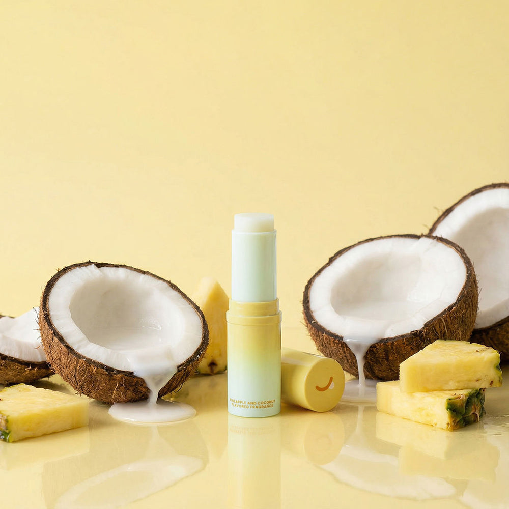 Sweetums Sweet Spot Fragrance Pineapple Coconut Crush displayed with coconuts and pineapple on a yellow background.
