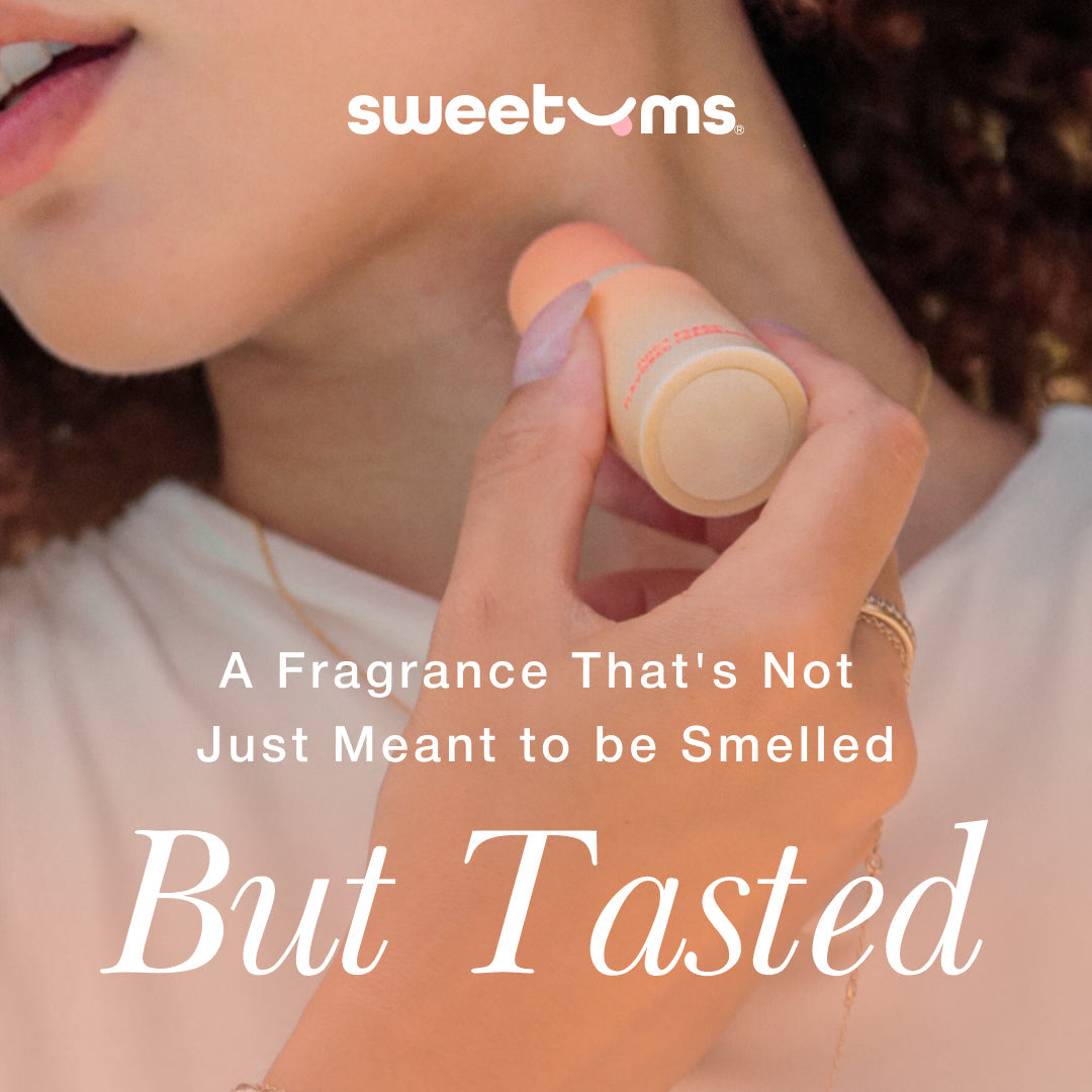 Woman applying Sweetums Sweet Spot Fragrance Pineapple Coconut Crush edible fragrance stick.